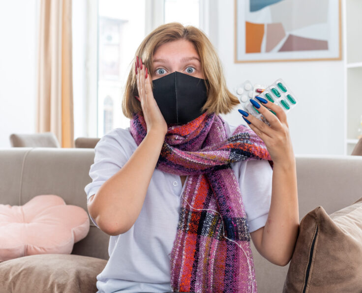 unhealthy young woman with warm scarf around neck with facial protective mask feeling unwell and sick suffering from flu and cold holding pills looking confused sitting on couch in light living room SSUCv3H4sIAAAAAAAACpyRz27DIAzG75P2DhHnRkpIQN1epdrBAbdBo1AB6TRVfffxJ1Scd8M/25/9mcf7W9eRBbwS5LN7pCjGSuvNBwdBWRPxcNi5QyPRteTuJj60AKUK1inQLVwgiNXAFSM0m9YJP3OS+ABh8+jT9B0JCHiJGgW+JMqKpxJ3NZGTsSOmCDk0zG9LZhUV8X91lsdXdQMXNOI3L9wYcagRipFTKSXfPwHdtbUGm1S2cXW3AnQqmBqlm1NCmUvTZsOaz17bhN1McGmF1+ZEW3uDRacTn6MmVr6C97FcVt4MEvGT7bWZY2zIBnZVIuNPpHCcKGMzpWyiM2UfMz/uBeX3VhV18jpVKMbiW8nWukobEHYeKB3w2E/LyPqZj+ce5HjscWSci0GMnE/x8M8/AAAA//8DAMfPSRKYAgAA